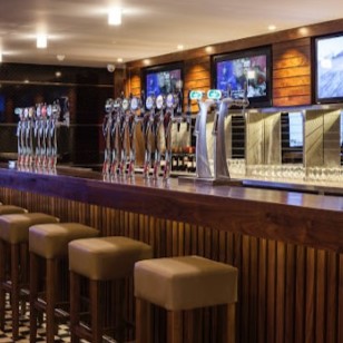 The UCD Clubhouse bar with stools aligned along the bartop